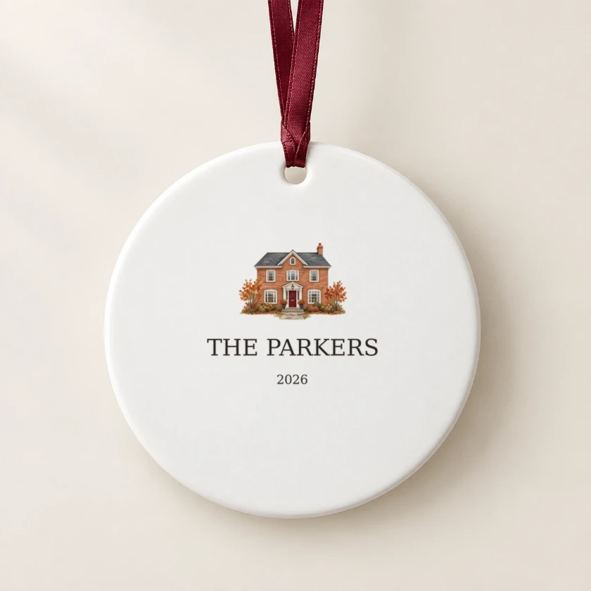 Round white ceramic ornament with a watercolor house, THE PARKERS and 2026